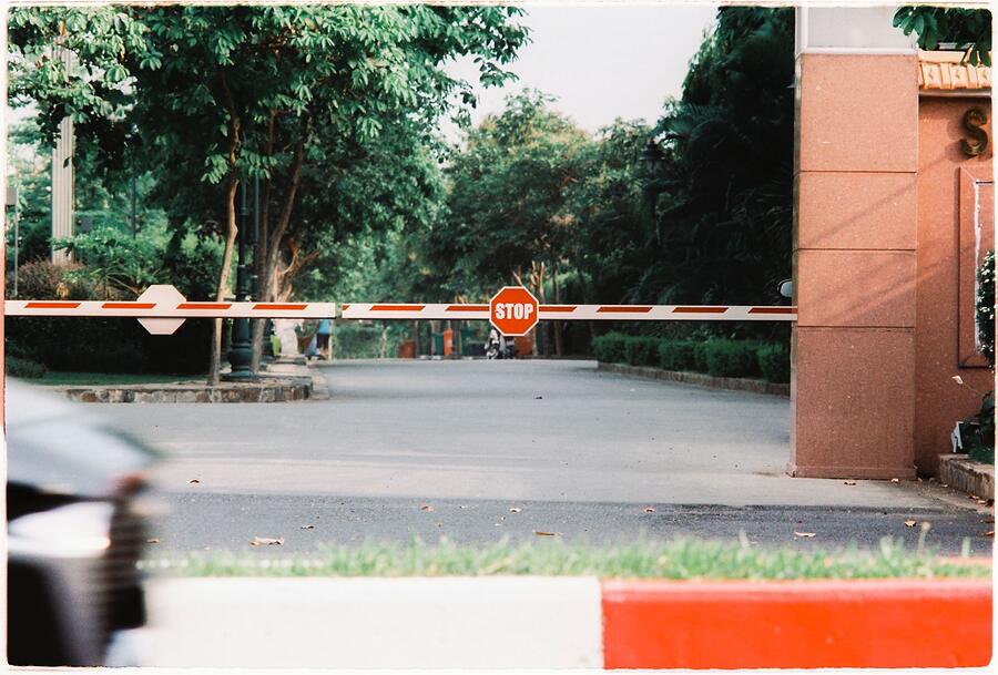 A boom gate lowered across a driveway