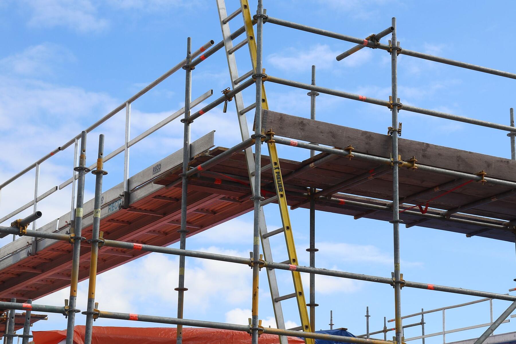 The steel frame of a building against an open sky